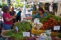 Customers purchase fresh vegetables from a farmers market in Boise, Idaho, USA.
