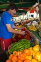 French vendor stocking produce at an outdoor market in Sanary sur Mer, Southern France.