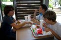 French teenage boys eat at a McDonalds fast food restaurant in Southern France.
