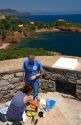Couple having a picnic lunch overlooking the Mediterranean Sea near Frejus in Southern France.