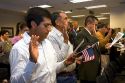 New United States citizens raise their right hand for citizenship oath ceremony in Idaho, USA.