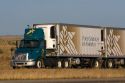 Transport truck hauling double refrigerated containers along Interstate 84 near Boise, Idaho, USA.