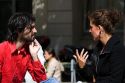 French man and woman have a conversation near the Sorbonne in Paris, France.