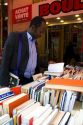 Customer shopping at a bookstore along Boulevard Saint-Michel in the Latin Quarter of Paris, France.