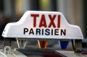 Sign atop a taxicab in Paris, France.