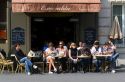 People dine outdoors at a sidewalk cafe in Paris, France.