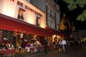 Restaurant exterior and nightlife in the Montmartre District of Paris, France.