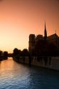 Nortre Dame cathedral and the River Seine at sunset in Paris, France.