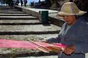 Mexican woman weaving with a loom in the town of Cholula, Puebla, Mexico.