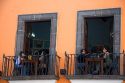 People dine on a restaurant balcony in the city of Puebla, Puebla, Mexico.