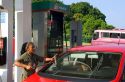 Mexican female attendant washing a car window at a full service gas station in Acapulco, Guerrero, Mexico.