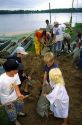 Adult and children volunteers fill sandbags for a flooded Mississippi River in Princeton, Iowa, USA.