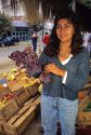 Chilean woman selling grapes at a produce stand in Valparaiso, Chile.