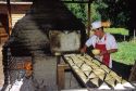 Chilean man cooking empanadas in a brick oven in Sanitiago, Chile.