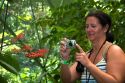 Tourists taking photos of butterflies in the Veragua Rainforest Research and Adventure Park near Limon, Costa Rica.