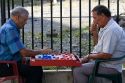 Costa Rican men playing a game of checkers on the street in Limon, Costa Rica.