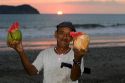 Man selling tropical drinks on the beach at sunset in the Manuel Antonio National Park in Puntarenas province, Costa Rica.
