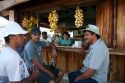 Server and customers at an outdoor cafe in Quepos, Costa Rica.