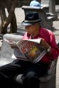 Costa Rican man reading a newspaper in San Jose, Costa Rica.