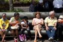 People sit on park benches in the city of San Jose, Costa Rica.