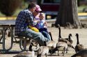 A family feeding canadian geese at Ann Morrison Park in Boise, Idaho, USA.