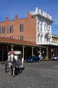 Tourists ride in a horse drawn carriage at Old Sacramento State Historic Park in Sacramento, Califorina, USA.