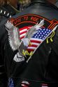 Patriotic patch on the back of a leather jacket at a motorcycle rally to create driver safety awareness in Boise, Idaho, USA.