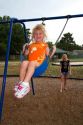 Mother pushing her 3 year old daughter in a swing, Brandon, Florida, USA. MR