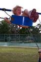 3 year old girl swinging on a swingset in Brandon, Florida, USA. MR