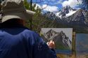 Artist painting McGown Peak and Stanley Lake in the Sawtooth Mountain Range near Stanley, Idaho, USA.