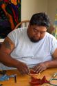 Native Pueblo man crafting a dreamcatcher in San Felipe Pueblo, New Mexico, USA.