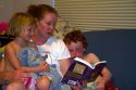 Mother reading to her children. MR