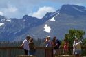 Tourists view the Rocky Mountains from a scenic overlook in the Rocky Mountain National Park, Colorado, USA.