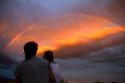 A couple viewing a rainbow at sunset in Boise, Idaho, USA.