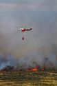 Helicopter with water bucket performing aerial firefighting on a wildfire in Eagle, Idaho, USA.