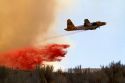 P2 fire bomber aircraft dropping phosphate fire retardant on a wildfire near Boise, Idaho, USA.