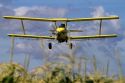 Crop duster spraying pesticide on a corn crop near Jerome, Idaho, USA.