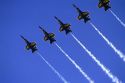 The Blue Angels F/A-18 Hornets fly in formation.