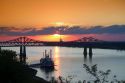 Sunset with steamboat under the Natchez-Vidalia Bridges spanning the Mississippi River between Vidalia, Louisiana and Natchez, Mississippi, USA.
