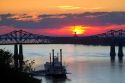 Sunset with steamboat under the Natchez-Vidalia Bridges spanning the Mississippi River between Vidalia, Louisiana and Natchez, Mississippi, USA.