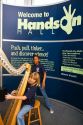 Child playing an electronic stringless harp at the Gulf Coast Exploreum Science Center in Mobile, Alabama, USA.