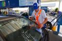 Gas station attendent washing an automobile windshield in Argentina.