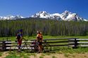 Touring bicyclists stop for a view of the Sawtooth Mountain Range near Stanley, Idaho, USA.