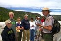 Park ranger giving a tour group information about the Upper Geyser Basin in Yellowstone National Park, Wyoming, USA.