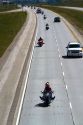 Motorcycles and automobiles travel on I-90 during Sturgis Motorcycle rally week west of Spearfish, South Dakota, USA.