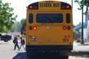 School bus stop with children crossing the street in Notus, Idaho, USA.