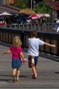 Brother and sister run on the boardwalk at Johns Pass Village located on the waterfront at Madeira Beach, Florida, USA.