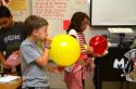 Students blowing up balloons as part of a science experiment in a fourh grade classroom at a public elementary school in Brandon, Florida, USA.