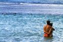 Couple stand in a pacific ocean lagoon on the island of Kauai, Hawaii, USA.