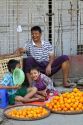 Burmese father and sons selling oranges on the street in (Rangoon) Yangon, (Burma) Myanmar.